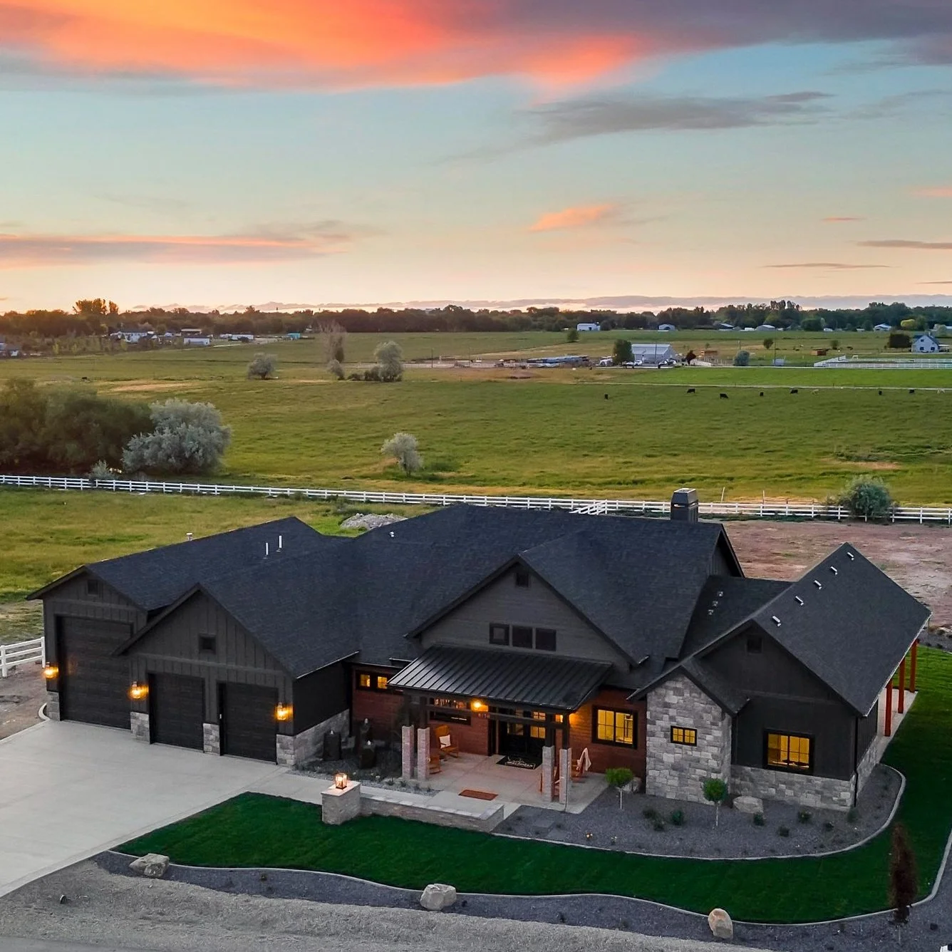 Bachman Custom Homes custom home exterior aerial at dusk, Treasure Valley Idaho — Photo: Bachman Custom Homes (bachmancustomhomes.com) — aerial dusk exterior